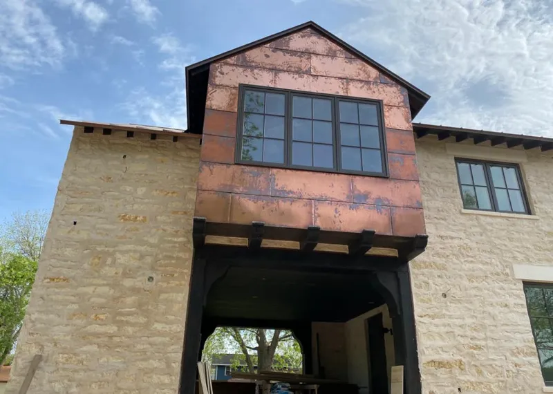 Copper metal panel facade on a stone building for Skylight Installation in Colorado Springs
