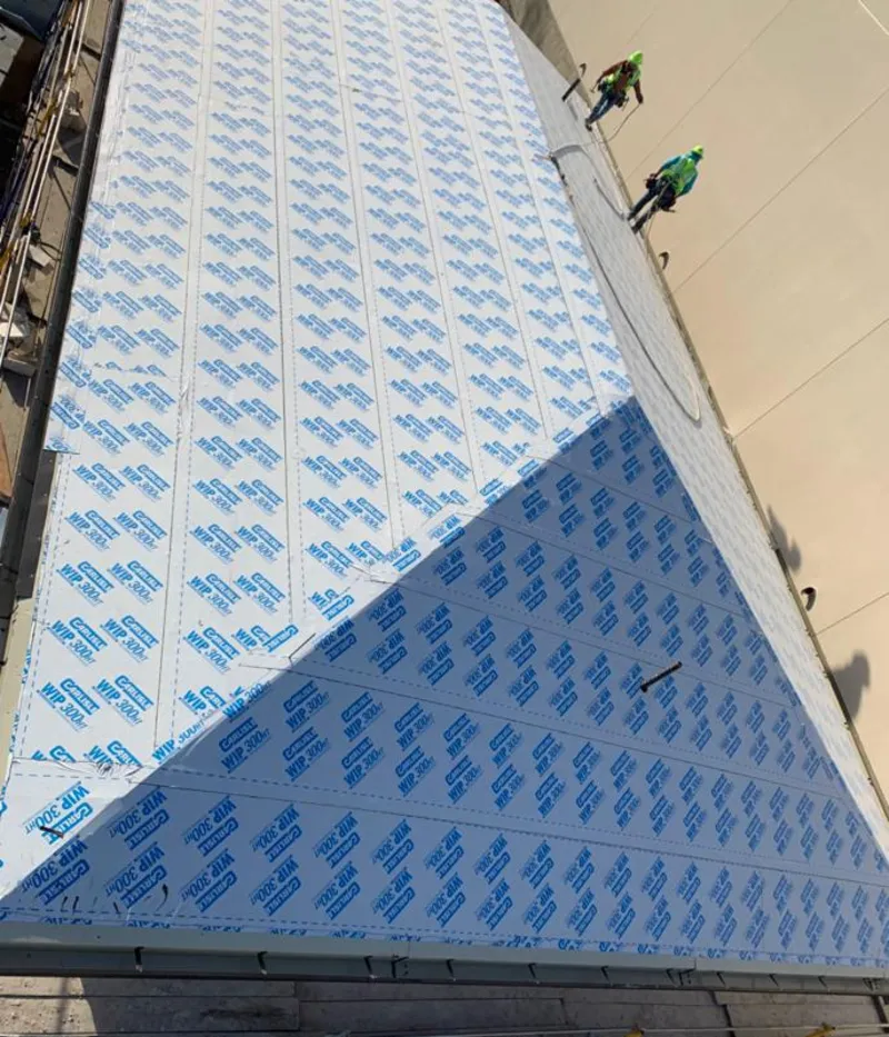 Professional roofers installing underlayment on a metal roof in Colorado Springs